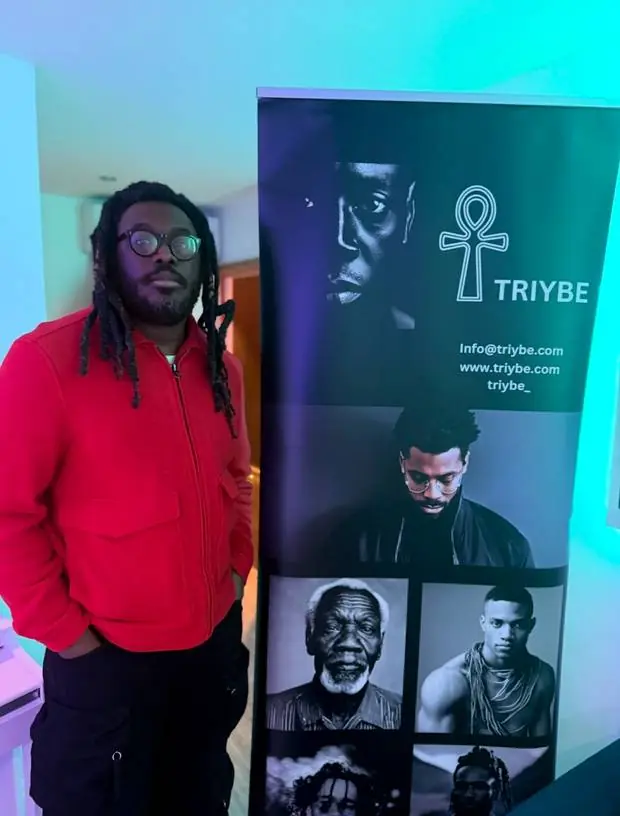 Shocka, grime artist, author and mental health advocate, beside a TRIYBE banner