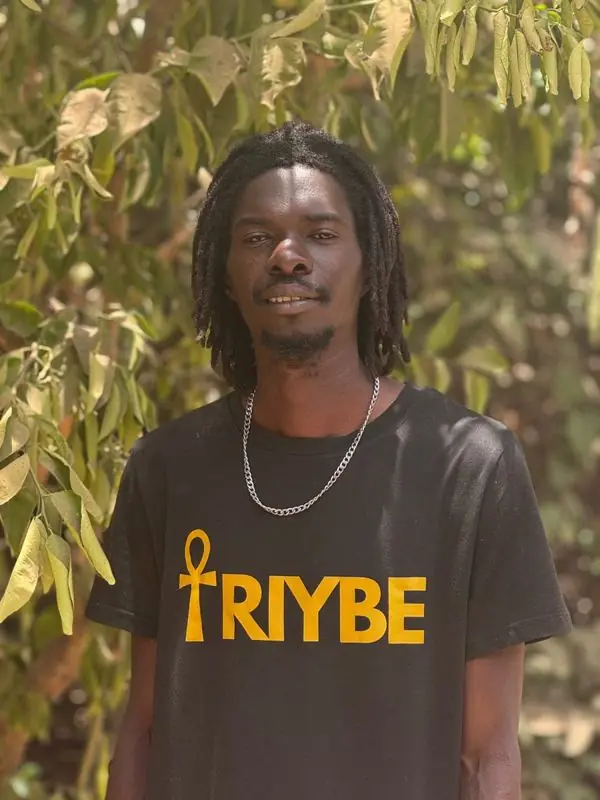 Organ, TRIYBE Volunteer Representative in The Gambia, wearing a TRIYBE T-shirt